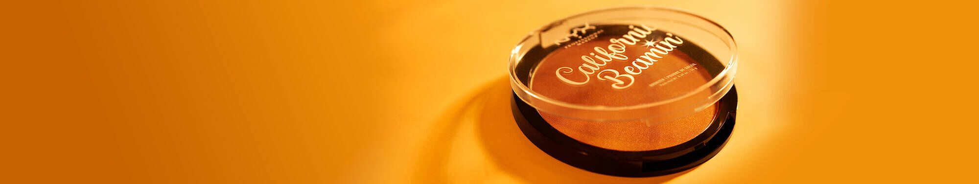 Puderniczka na pomarańczowym tle, napis California.