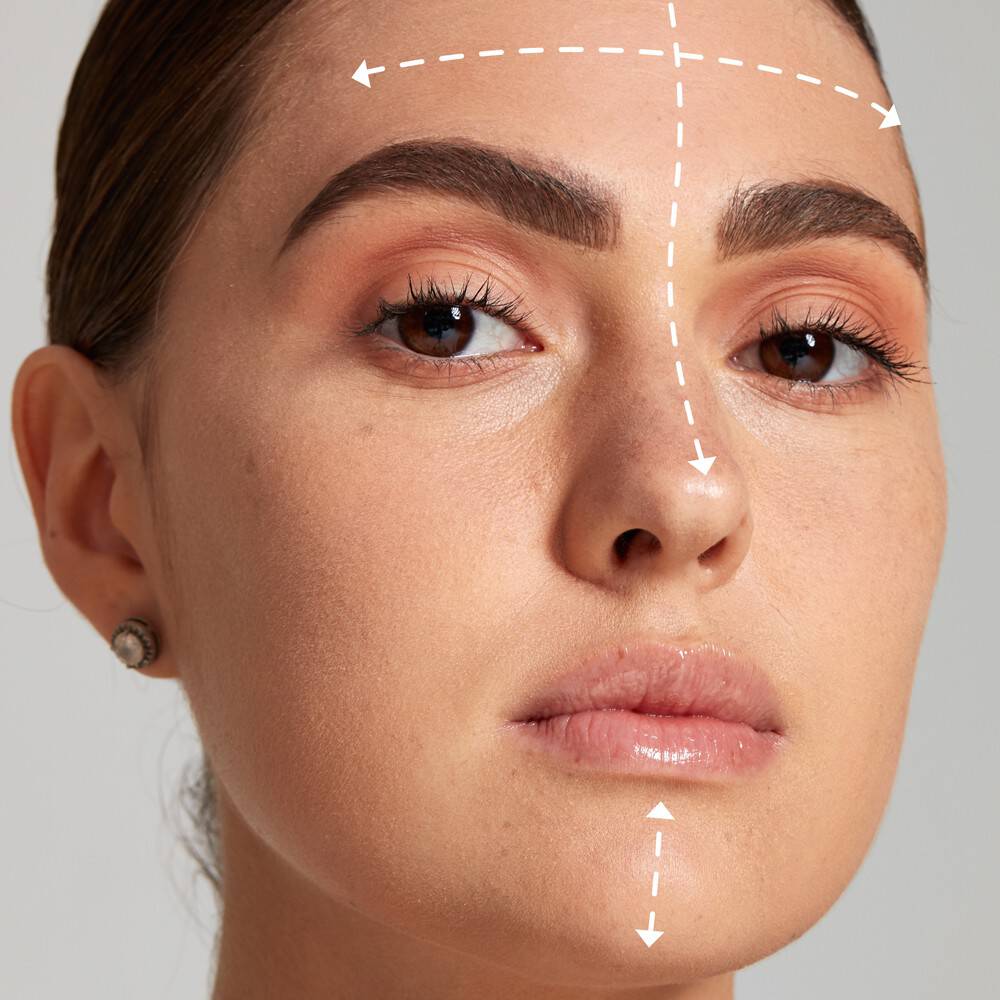 Kobieca twarz z zaznaczoną białymi strzałkami strefą T